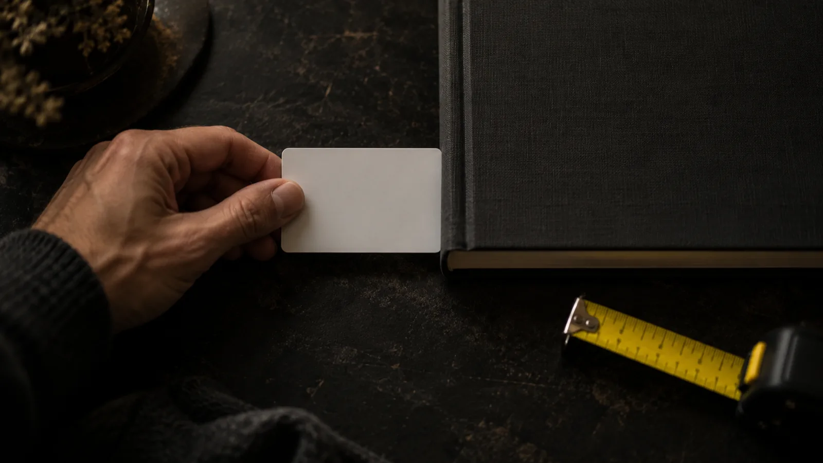 A plastic card held against the edge of a book to measure it